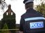 Police officer standing outside a derelict building