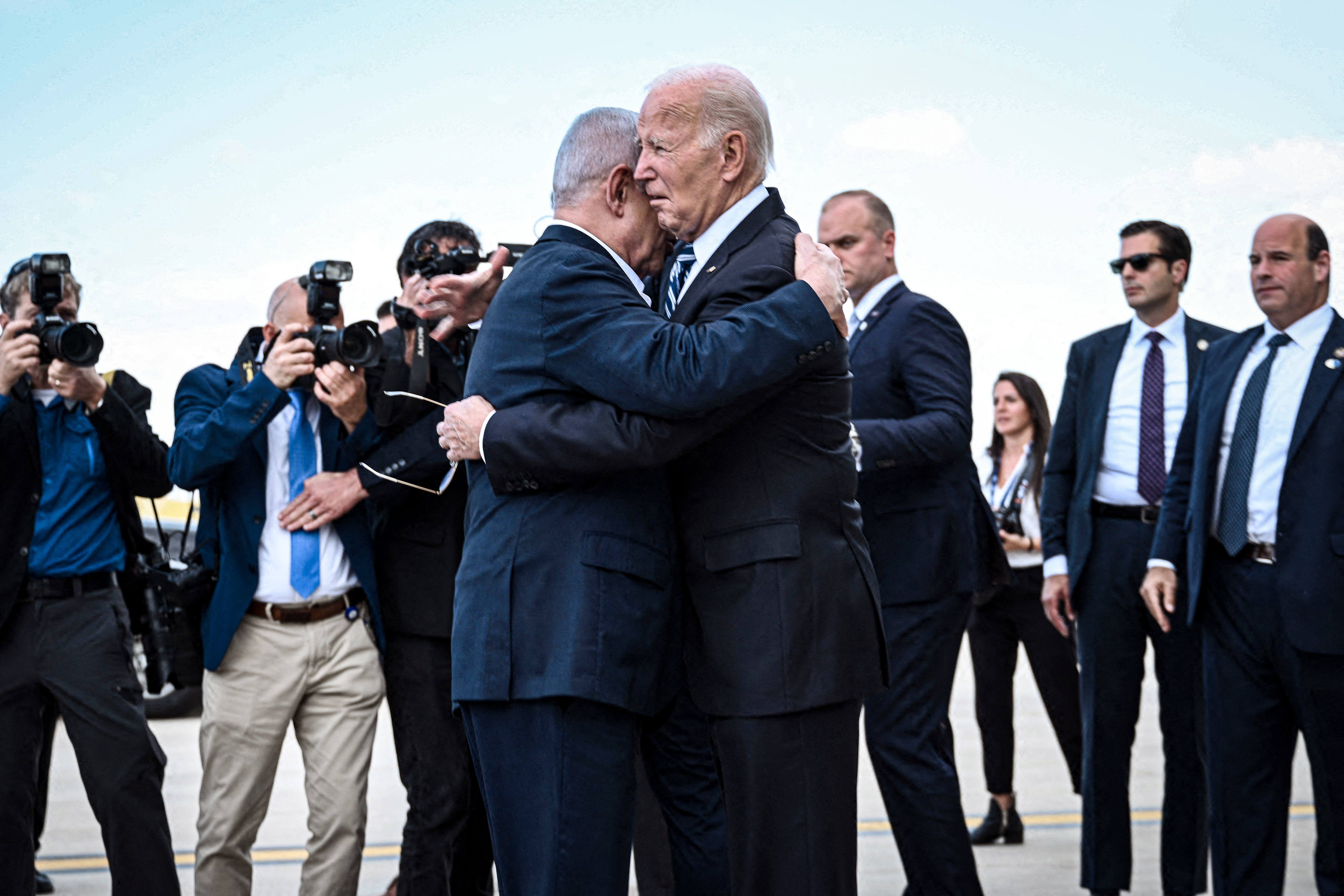 TOPSHOT - Israel Prime Minister Benjamin Netanyahu (L) hugs US President Joe Biden upon his arrival at Tel Aviv's Ben Gurion airport on October 18, 2023, amid the ongoing battles between Israel and the Palestinian group Hamas. Biden landed in Israel on October 18, on a solidarity visit following Hamas attacks that have led to major Israeli reprisals. (Photo by Brendan SMIALOWSKI / AFP) (Photo by BRENDAN SMIALOWSKI/AFP via Getty Images)