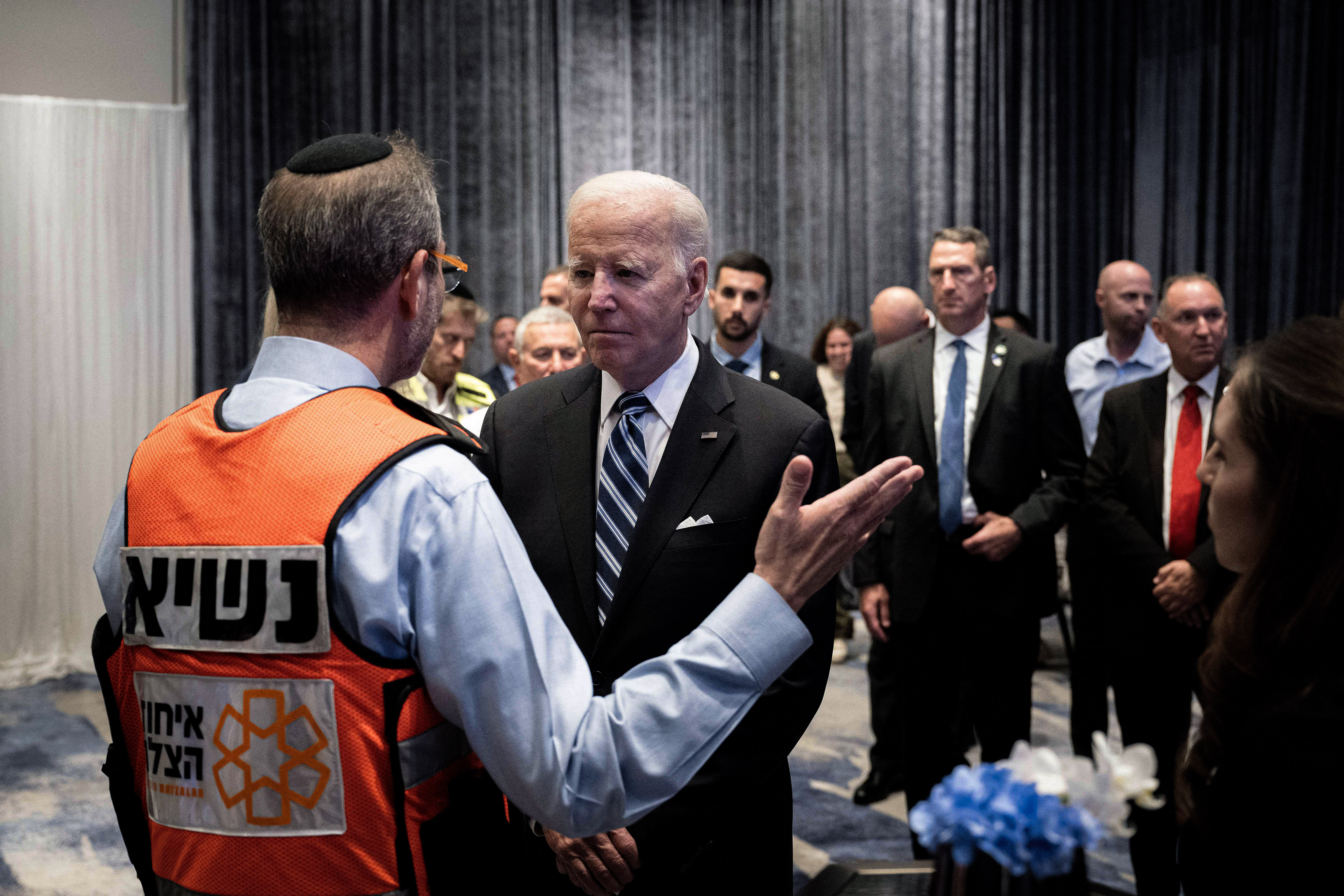 US President Joe Biden speaks with Eli Beer, Founder of United Hatzalah of Israel, while meeting with people in Tel Aviv on October 18, 2023, effected by this month's attacks on Israel by the Palestinian militant group Hamas. Thousands of people, both Israeli and Palestinians have died since October 7, 2023, after Palestinian Hamas militants based in the Gaza Strip entered southern Israel in a surprise attack, holding some people hostage, that lead Israel to declare war on Hamas in Gaza on October 8. (Photo by Brendan Smialowski / AFP) (Photo by BRENDAN SMIALOWSKI/AFP via Getty Images)