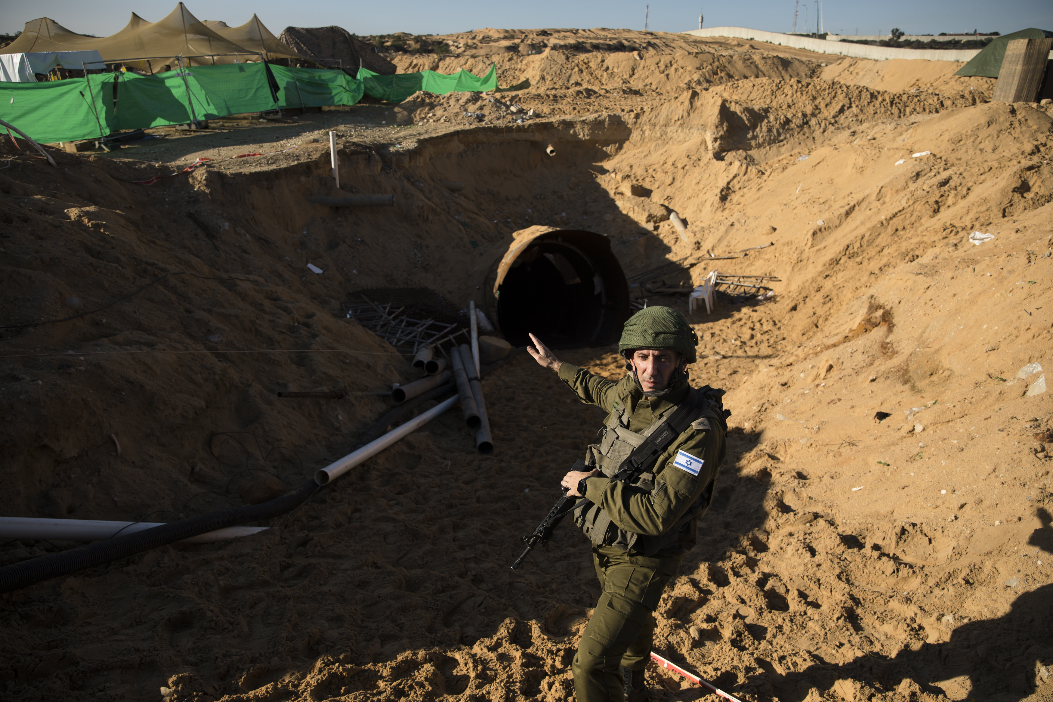 NORTHERN GAZA, GAZA - DECEMBER 15: Head of the IDF spokesperson Unit, Daniel Hagari, stands at the opening to a tunnel near the border with Israel on December 15, 2023, northern Gaza Strip. The Israel Defense Forces say this is the largest tunnel they've found yet in Gaza, comprising branches that extend well over four kilometers (2.5 miles) and reaches 400 meters (1,310 feet) from the Erez crossing. The IDF alleges the project of building the tunnel was led by Mohammed Sinwar, the brother of Hamas leader Yahya Sinwar and was used as part of the Oct. 7 attack, funnelling fighters near the Erez crossing and Israeli border communities. As the IDF have pressed into Gaza as part of their campaign to defeat Hamas, they have highlighted the militant group's extensive tunnel network as emblematic of the way the group embeds itself and its military activity in civilian areas. (Photo by Amir Levy/Getty Images)