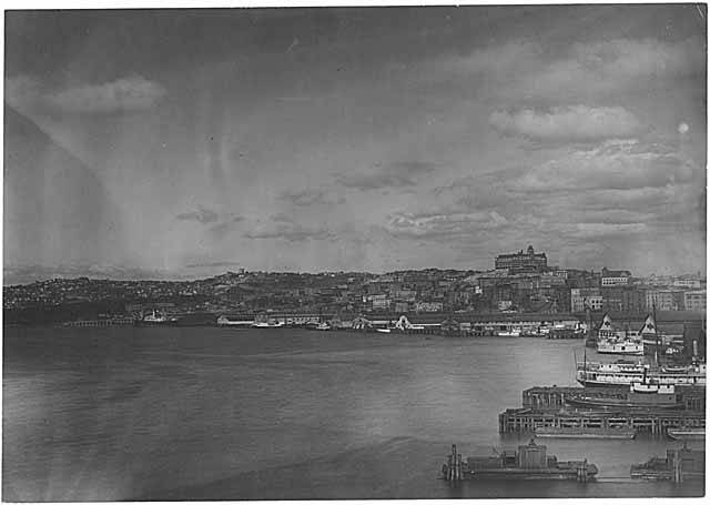 File:Elliott Bay looking northeast toward the Seattle waterfront with the Washington Hotel and Denny Hill in the distance, probably (WARNER 97).jpg