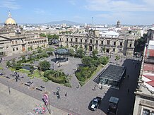 A public square with colonial buildings.