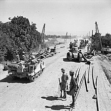 Indian tank passes wrecked Vichy French tank on road to Damascus