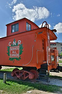 The cupola section (vertical projection with window) on a restored caboose on exhibit at the Toronto Railway Museum