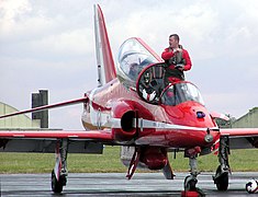 A Red Arrows pilot climbs out of his Hawk after a display
