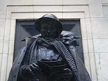 Head and shoulders of a bronze statue in military dress