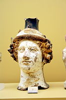 Terracotta vase in the shape of Dionysus' head, c. 410 BC; on display in the Ancient Agora Museum in Athens, housed in the Stoa of Attalus