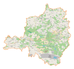 Mapa konturowa powiatu bełchatowskiego, blisko górnej krawiędzi nieco na prawo znajduje się punkt z opisem „Kolonia Karczmy”