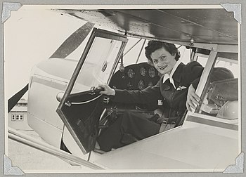 Australian Women Pilots' Association member Meg Cornwell in the cockpit of Auster J-5G Cirrus Autocar monoplane VH-ADY at an airfield, 1954.