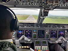 An Embraer 145 on final approach to runway 22