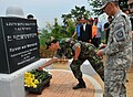 Soldiers lay flowers at the memorial for the Hill 303 massacre