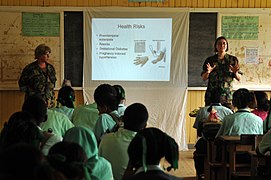 US Navy 081120-N-8907D-142 Cmdr. Andrea Parodi and Lt. j.g. Molly Moffatt give a pregnancy awareness class to the students of Port Kaituma Secondary School.jpg