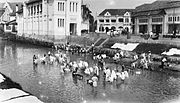 Another view focusing on a group of local cloth-washer in the canal.