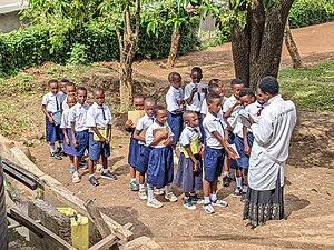 Eine Schulklasse wartet darauf, dass ihre Lehrerin ihre in Kinyarwanda verfassten Texte korrigiert