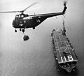 An HMR-163 HRS-2 over USS Sicily (CVE-118), 1952.