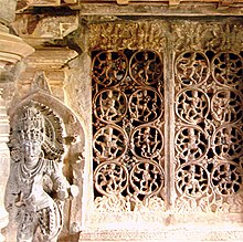 An ornate temple statue and grill work