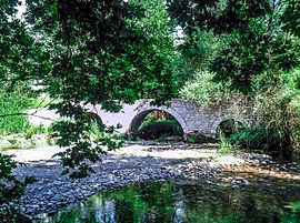 The three arches stone bridge of Paos River near Dafni