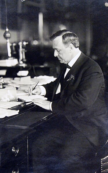 File:Secretary of the Navy Josephus Daniels reviews a document at his desk, Washington, D.C. (27586199835).jpg