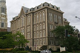 The main building of St. Ignatius College Prep in Chicago, Illinois, designed by Canadian architect Toussaint Menard, is a classic example of the style. It is one of the five extant, public buildings in Chicago that predate the Great Chicago Fire of 1871