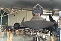 An SR-71 Blackbird under the wing of the Spruce Goose.