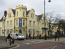 A pub with yellow walls on a street corner