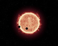 Artist's view of planets transiting red dwarf star in TRAPPIST-1 system[14]