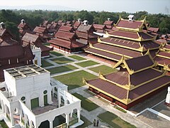 Aerial view of large compound with wooden tiered buildings with red and gold decorations