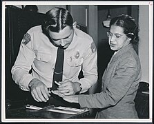 Rosa Parks being fingerprinted by Deputy Sheriff D.H. Lackey after being arrested on February 22, 1956, during the Montgomery bus boycott - Original.jpg