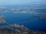 A long floating bridge crossing a lake in a suburban area