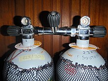 Two 12-litre steel cylinders with DIN outlet valves connected by a manifold with a central isolation valve.