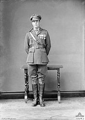 Full-length portrait of man in military uniform wearing medals