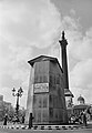 Encased equestrian statue of Charles I in Trafalgar Square with a notice giving directions to the nearest public air raid shelter