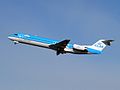 A KLM Cityhopper Fokker 100 taking off Amsterdam.