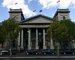 A large building with words TRADES HALL above entrance