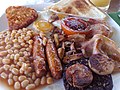 Image 24The full breakfast is among the best known British dishes, consisting of fried egg, sausage, bacon, mushrooms, baked beans, toast, fried tomatoes, and sometimes white or black pudding. (from Culture of the United Kingdom)