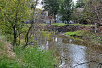 A small stream winds through a town.