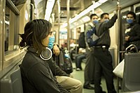 People in Mexico City wear masks on a train due to the 2009 swine flu outbreak