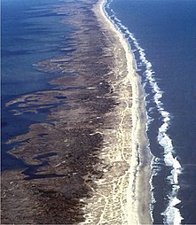 An overhead image of a long and thin barrier island.