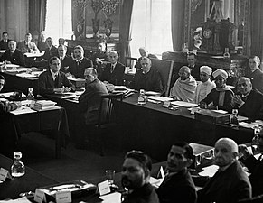 British prime minister, Ramsay MacDonald, to the right of Gandhi at the 2nd Round Table Conference. Foreground, fourth from left, is B. R. Ambedkar representing the "Depressed Classes."