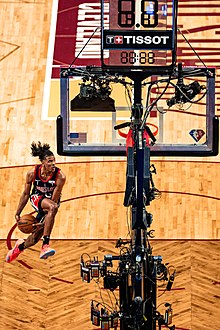 Man dunking a basketball.