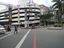 An intersection with a crossing pedestrian.