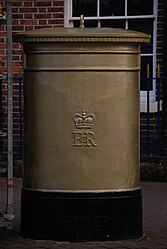 Rear view of the Olympic gold pillar box in Leek, Staffordshire.