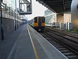 Class 313 unit departs with a northbound Overground service