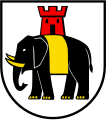 D'argento, all'elefante di nero, allumato del campo, difeso, unghiato e gualdrappato d'oro e sostenente una torre di rosso, aperta e finestrata del secondo