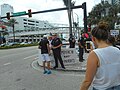 Lone Trump supporter with "Gays for Trump" and "Impeach Nazi Democrats" signs confronted by a protester