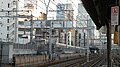 View from the platform of Kanda Station, October 2009. A bridge pylon is being built to carry a viaduct of the future Ueno–Tokyo Line. A ramp structure can be seen in the background.
