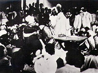 Congress "extremist" Bal Gangadhar Tilak speaking in 1907 as the party split into the Moderates and the Extremists. Seated at the table is Aurobindo Ghosh and to his right is Lala Lajpat Rai, both allies of Tilak.