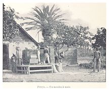 An outdoor maize mill, with people working