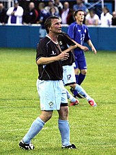 Chris Brass standing on a grass field