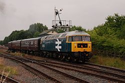 Class 47 No. 47292 departs Ruddington station.